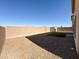 Spacious backyard with gravel, artificial turf, and a tall block perimeter wall at 5308 Hollyridge St, North Las Vegas, NV 89081