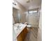 Bathroom featuring a single sink vanity, a tub-shower combo, and wood-look flooring at 5308 Hollyridge St, North Las Vegas, NV 89081