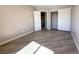 Neutral bedroom featuring a closet with sliding doors, wood-look flooring, and a doorway at 5308 Hollyridge St, North Las Vegas, NV 89081