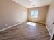 Neutral bedroom featuring wood-look flooring, a window, and neutral colored walls at 5308 Hollyridge St, North Las Vegas, NV 89081