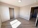 Bedroom with wood-look flooring, closet with sliding doors, and neutral colored walls at 5308 Hollyridge St, North Las Vegas, NV 89081