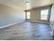 Spacious bedroom featuring two large windows, wood-look tile, and neutral paint at 5308 Hollyridge St, North Las Vegas, NV 89081