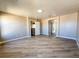 Spacious bedroom with wood-look flooring, neutral paint, and a view of another room at 5308 Hollyridge St, North Las Vegas, NV 89081