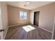 Neutral bedroom featuring a closet with sliding doors, wood-look flooring, and a window at 5308 Hollyridge St, North Las Vegas, NV 89081