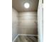 Walk-in closet with wood-look tile and multiple shelves on walls at 5308 Hollyridge St, North Las Vegas, NV 89081