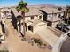 Two-story home showcasing a desert-landscaped front yard, tile roof, and a two-car garage at 5308 Hollyridge St, North Las Vegas, NV 89081