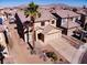 Two-story home showcasing a desert-landscaped front yard, tile roof, and a two-car garage at 5308 Hollyridge St, North Las Vegas, NV 89081