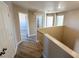 Second story hallway featuring neutral paint, doors to bedrooms and bathrooms, and wood look tile at 5308 Hollyridge St, North Las Vegas, NV 89081