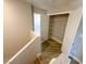 Hallway with wood-look tile, textured walls and pantry closet with white wire shelving at 5308 Hollyridge St, North Las Vegas, NV 89081