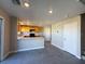 Open-concept kitchen with wood cabinetry, modern appliances and tile flooring at 5308 Hollyridge St, North Las Vegas, NV 89081