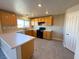 Bright kitchen featuring wood cabinetry, modern appliances, countertops, and tile flooring at 5308 Hollyridge St, North Las Vegas, NV 89081