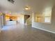 View of the open-concept living room and kitchen, featuring tile floors and natural light at 5308 Hollyridge St, North Las Vegas, NV 89081