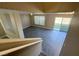 View from stairway to the living room featuring tile floors, natural light and backyard access at 5308 Hollyridge St, North Las Vegas, NV 89081
