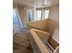 Stairway with wood treads, white handrail, and updated fixtures at 5308 Hollyridge St, North Las Vegas, NV 89081