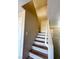Stairway with painted risers, wood treads, white handrail, and updated fixtures at 5308 Hollyridge St, North Las Vegas, NV 89081