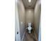 Powder room with wood-look tile, toilet, and neutral paint at 5308 Hollyridge St, North Las Vegas, NV 89081