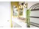 Bathroom with a white vanity and mirror with decorative plants and modern lighting at 5673 Coaldale Pl, Las Vegas, NV 89110