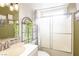 Well-lit bathroom featuring a shower over tub with glass enclosure and decorative plants for a refreshing touch at 5673 Coaldale Pl, Las Vegas, NV 89110