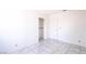 The bedroom is painted white with tile flooring and an empty closet at 5673 Coaldale Pl, Las Vegas, NV 89110