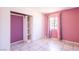 Bright bedroom with built-in shelves, tile floor and a window at 5673 Coaldale Pl, Las Vegas, NV 89110