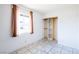 Bright bedroom featuring neutral walls, tile flooring, and a built-in closet with shelves at 5673 Coaldale Pl, Las Vegas, NV 89110