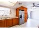 Bright kitchen with stainless steel refrigerator and light wood cabinets, with backyard access at 5673 Coaldale Pl, Las Vegas, NV 89110