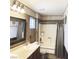 Bathroom with a light sink countertop, framed mirror, and a combination shower and tub with gray curtains at 5929 Gentle Creek Ln, North Las Vegas, NV 89031