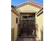 Inviting home entrance with wrought iron security gate and a decorative trimmed front door at 5929 Gentle Creek Ln, North Las Vegas, NV 89031