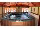 Relaxing indoor hot tub with orange curtains, tan walls, and seating at 5929 Gentle Creek Ln, North Las Vegas, NV 89031