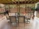 Charming outdoor patio with lattice privacy screen, and dining table at 5929 Gentle Creek Ln, North Las Vegas, NV 89031