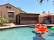 Inviting pool area with a covered patio, outdoor kitchen and lush landscaping perfect for outdoor relaxation at 5929 Gentle Creek Ln, North Las Vegas, NV 89031