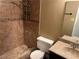 Bathroom featuring tiled shower with glass door and a granite vanity at 608 Watkins Dr, Las Vegas, NV 89107