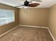 A neutral bedroom with a ceiling fan and a window providing natural light at 608 Watkins Dr, Las Vegas, NV 89107
