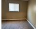 Neutral bedroom featuring window with blinds and neutral carpet at 608 Watkins Dr, Las Vegas, NV 89107