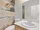 Modern bathroom features decorative tiling, glass shower, and vanity sink at 6307 Dusty Mile Ct, North Las Vegas, NV 89031