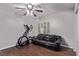 Well-lit room featuring a ceiling fan, wood floors, exercise equipment, and comfortable seating at 6307 Dusty Mile Ct, North Las Vegas, NV 89031