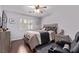 Cozy bedroom boasts wood floors, shuttered window, and entertainment seating at 6307 Dusty Mile Ct, North Las Vegas, NV 89031