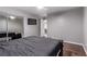 Light and airy bedroom features wood floors, mirrored closet, and mounted television at 6307 Dusty Mile Ct, North Las Vegas, NV 89031