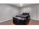 Well-lit bedroom features wood floors, shuttered window, and simple decor at 6307 Dusty Mile Ct, North Las Vegas, NV 89031