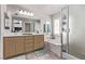 Bright bathroom with a dual sink vanity, soaking tub, walk-in shower, and plantation shutters at 6307 Dusty Mile Ct, North Las Vegas, NV 89031