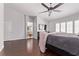 Main bedroom featuring hardwood floors, a ceiling fan, and a view to the en-suite bathroom at 6307 Dusty Mile Ct, North Las Vegas, NV 89031