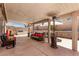 Spacious covered patio featuring outdoor kitchen, seating, and shade at 6307 Dusty Mile Ct, North Las Vegas, NV 89031