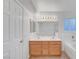 Bright bathroom featuring double sink vanity, tub, updated lighting, and tile flooring at 641 Bay Bridge Dr, North Las Vegas, NV 89032