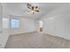 Spacious bedroom with neutral carpet, ceiling fan, window, and ensuite access at 641 Bay Bridge Dr, North Las Vegas, NV 89032