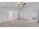Bright bedroom featuring neutral carpet, ceiling fan, access to ensuite and walk-in closet at 641 Bay Bridge Dr, North Las Vegas, NV 89032
