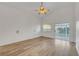 Bright bedroom with laminate floors, ceiling fan, sliding glass doors to the backyard, and recessed lights at 641 Bay Bridge Dr, North Las Vegas, NV 89032