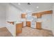 Well-lit kitchen with tile flooring, white appliances, and breakfast bar, offering a functional space at 641 Bay Bridge Dr, North Las Vegas, NV 89032