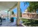 Backyard featuring a covered patio, artificial turf, and a sparkling swimming pool at 7537 Splashing Rock Dr, Las Vegas, NV 89131