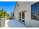 Private balcony with double doors offers views of lush greenery and neighborhood scenery at 7537 Splashing Rock Dr, Las Vegas, NV 89131