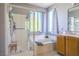 Bathroom featuring a separate tub and shower with tile surround and a large window at 7537 Splashing Rock Dr, Las Vegas, NV 89131
